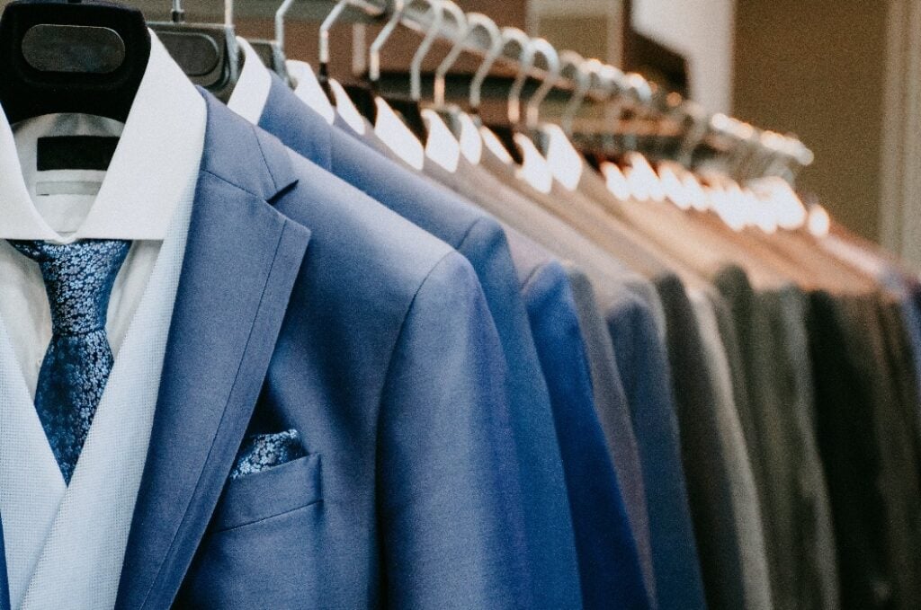 Men suit jackets on hanger in a shop